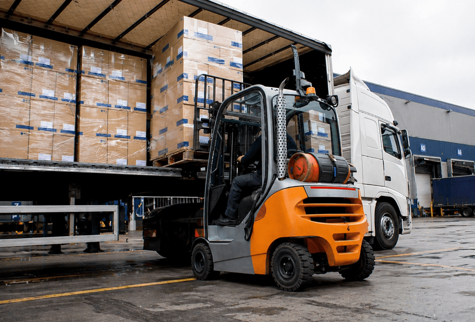 Forklift loading palletised freight onto a Quick Cargo truck